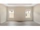 Bright and airy bedroom with neutral decor and two windows at 12460 Shimmering Oak Cir, Venice, FL 34293