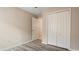 Bedroom with wood-look flooring and a double door closet at 12460 Shimmering Oak Cir, Venice, FL 34293