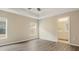 Spacious bedroom with wood-look flooring and an ensuite bathroom at 12460 Shimmering Oak Cir, Venice, FL 34293
