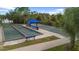 Community bocce ball courts with benches and shade umbrellas at 12460 Shimmering Oak Cir, Venice, FL 34293