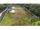 Fenced dog park with agility equipment and shaded seating at 12460 Shimmering Oak Cir, Venice, FL 34293