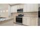 Modern kitchen with granite countertops and stainless steel appliances at 12460 Shimmering Oak Cir, Venice, FL 34293