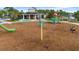 Community playground with play structures and shaded seating at 12460 Shimmering Oak Cir, Venice, FL 34293