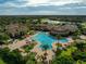 Community pool and clubhouse with palm trees at 12950 Basilica Dr, Venice, FL 34293