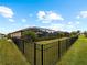 Expansive backyard with fenced perimeter and lush landscaping at 12950 Basilica Dr, Venice, FL 34293