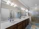 Double vanity bathroom with a large walk-in shower at 12950 Basilica Dr, Venice, FL 34293