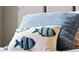 Close-up of decorative pillow with embroidered fish design at 12950 Basilica Dr, Venice, FL 34293