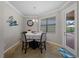 Bright breakfast nook features a table with four chairs and access to the backyard at 12950 Basilica Dr, Venice, FL 34293