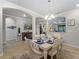 Bright dining room features a white table, and seating for six at 12950 Basilica Dr, Venice, FL 34293