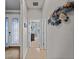Elegant hallway with access to bedrooms and featuring glass-paned door at 12950 Basilica Dr, Venice, FL 34293
