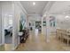 Open floor plan with arches, tile floors, and views to bedrooms and dining area at 12950 Basilica Dr, Venice, FL 34293