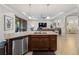 Spacious kitchen with island and stainless steel dishwasher at 12950 Basilica Dr, Venice, FL 34293