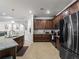 Updated kitchen with dark wood cabinets and stainless steel appliances at 12950 Basilica Dr, Venice, FL 34293