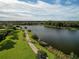 Scenic walking path alongside a tranquil lake at 12950 Basilica Dr, Venice, FL 34293