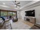 Comfortable living room, with pool access, and large TV at 12950 Basilica Dr, Venice, FL 34293