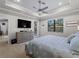 Main bedroom with king bed, dresser, and access to the backyard at 12950 Basilica Dr, Venice, FL 34293