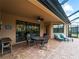 Covered patio with seating area and view of the pool and spa at 12950 Basilica Dr, Venice, FL 34293