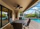 Covered patio with seating area overlooking the refreshing pool at 12950 Basilica Dr, Venice, FL 34293