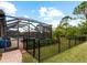 Inviting pool area with screened enclosure and fenced backyard at 12950 Basilica Dr, Venice, FL 34293