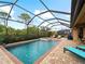 Screened pool and spa with lounge chairs and patio furniture at 12950 Basilica Dr, Venice, FL 34293