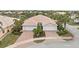 Two-car garage villa with paver driveway, landscaping, and neighborhood view at 13364 Dimarco St, Venice, FL 34293