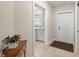 Entryway with console table, mirror, and view into the laundry room at 13364 Dimarco St, Venice, FL 34293