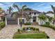 Beautiful home with a modern design, palm trees, and a paved driveway at 1371 Grebe Dr, Punta Gorda, FL 33950
