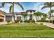Luxury home with modern design, palm trees and paved driveway at 1371 Grebe Dr, Punta Gorda, FL 33950