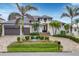 Luxury home with a modern design, palm trees, and a paved driveway at 1371 Grebe Dr, Punta Gorda, FL 33950