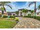 Modern home with palm trees and a large driveway at 1371 Grebe Dr, Punta Gorda, FL 33950