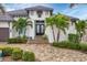 Exterior of house with landscaping, pavers, and double doors at 1371 Grebe Dr, Punta Gorda, FL 33950