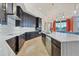 Gourmet kitchen with dark cabinetry, marble countertops, and high-end appliances at 1371 Grebe Dr, Punta Gorda, FL 33950