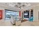 Spacious living room with coffered ceiling, large TV, and access to pool at 1371 Grebe Dr, Punta Gorda, FL 33950