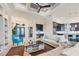 Spacious living room with coffered ceiling, large TV, and access to pool at 1371 Grebe Dr, Punta Gorda, FL 33950