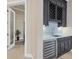 Custom wet bar with wine storage, marble countertops, and under-counter refrigerator at 1371 Grebe Dr, Punta Gorda, FL 33950