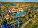 Community pool and clubhouse with palm trees and surrounding homes at 13836 Alafaya St, Venice, FL 34293