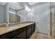 Bathroom with double vanity, granite countertop, and walk-in shower at 13836 Alafaya St, Venice, FL 34293