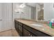 Double vanity bathroom with granite countertop and dark brown cabinets at 13836 Alafaya St, Venice, FL 34293