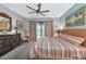 Spacious bedroom with king-size bed, dresser, and patio access at 13836 Alafaya St, Venice, FL 34293