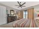 Comfortable bedroom with king-size bed, dresser, and view to backyard at 13836 Alafaya St, Venice, FL 34293