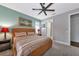 Bedroom with queen-size bed, ceiling fan, and access to bathroom at 13836 Alafaya St, Venice, FL 34293