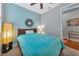 Bedroom with full-size bed, ceiling fan, and decorative mirror at 13836 Alafaya St, Venice, FL 34293
