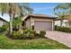 Single-story home with a two-car garage and landscaped front yard at 13836 Alafaya St, Venice, FL 34293