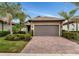 One-story home with a two-car garage and brick paver driveway at 13836 Alafaya St, Venice, FL 34293