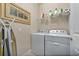 Convenient laundry room with washer, dryer, and shelving at 13836 Alafaya St, Venice, FL 34293
