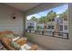 Cozy balcony with wicker seating and views of community at 1555 Tarpon Center Dr # 238, Venice, FL 34285