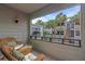 Private balcony with wicker chairs and courtyard view at 1555 Tarpon Center Dr # 238, Venice, FL 34285