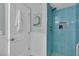 Bathroom with blue tiled walk-in shower and modern fixtures at 1555 Tarpon Center Dr # 238, Venice, FL 34285