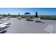 Beachfront deck with tables, chairs, and lounge chairs at 1555 Tarpon Center Dr # 238, Venice, FL 34285