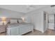 Bright bedroom with beach decor, large closet doors, and a stacked washer and dryer at 1555 Tarpon Center Dr # 238, Venice, FL 34285